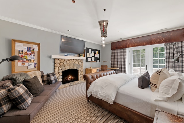 bedroom with access to outside, a fireplace, and crown molding