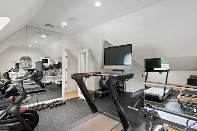 workout room with wood-type flooring and vaulted ceiling