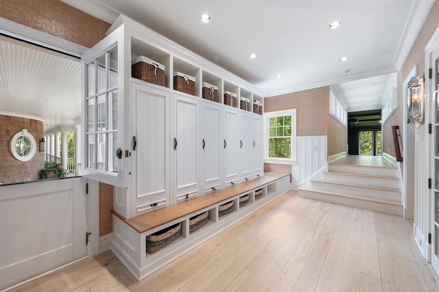 mudroom featuring light hardwood / wood-style flooring and crown molding