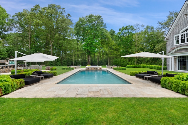 view of swimming pool with outdoor lounge area, a yard, an in ground hot tub, and a patio