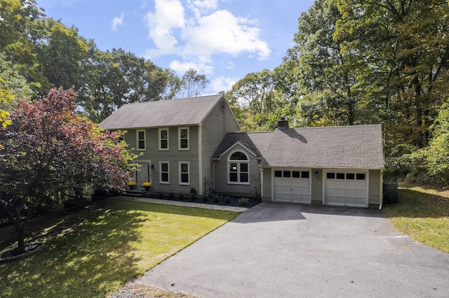 colonial house featuring a garage and a front yard