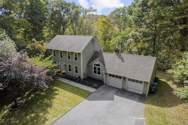 colonial-style house with a garage and a front yard