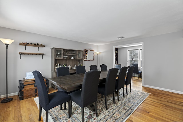 dining space with hardwood / wood-style floors