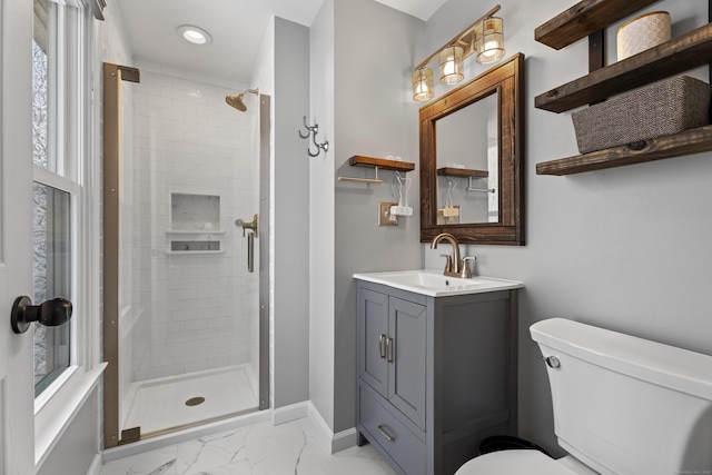 bathroom with toilet, a wealth of natural light, vanity, and a shower with shower door