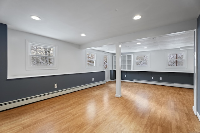 basement with a baseboard radiator and light wood-type flooring