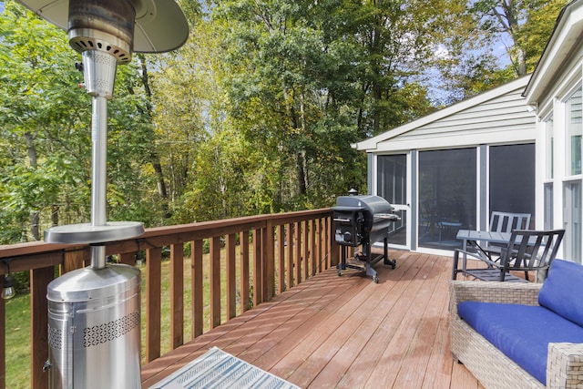 wooden terrace featuring a sunroom and grilling area