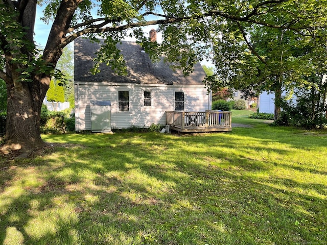 23 Nassau Cir E, Hartford, CT 06118 - back of property with a deck, a chimney, a lawn, and roof with shingles