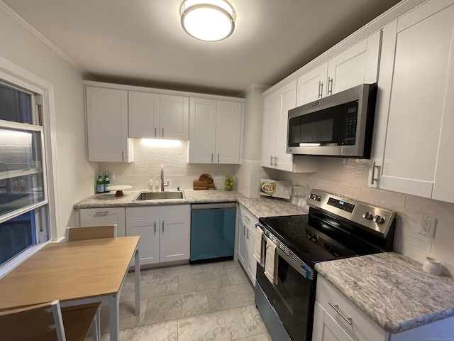 23 Nassau Cir E, Hartford, CT 06118 - kitchen featuring stainless steel appliances, decorative backsplash, white cabinetry, and ornamental molding