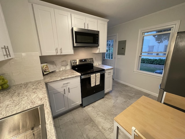 23 Nassau Cir E, Hartford, CT 06118 - kitchen with appliances with stainless steel finishes, backsplash, light countertops, white cabinets, and ornamental molding