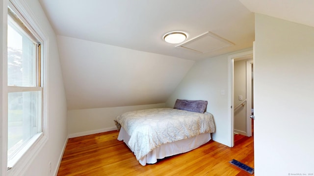 23 Nassau Cir E, Hartford, CT 06118 - bedroom with multiple windows, light wood-style flooring, vaulted ceiling, and attic access