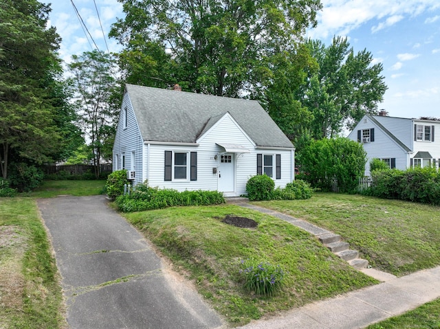 23 Nassau Cir E, Hartford, CT 06118 - view of front of home featuring roof with shingles, asphalt driveway, and a chimney