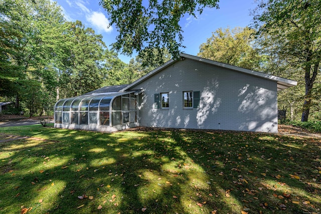 back of house with a lawn