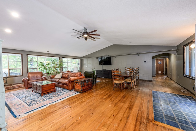 living room featuring ceiling fan, lofted ceiling, and hardwood / wood-style floors