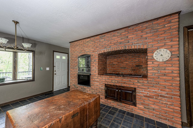 interior space featuring an inviting chandelier, black oven, and a textured ceiling