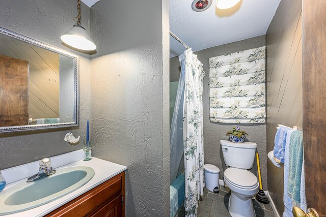 full bathroom with vanity, wood walls, toilet, and shower / bathtub combination with curtain