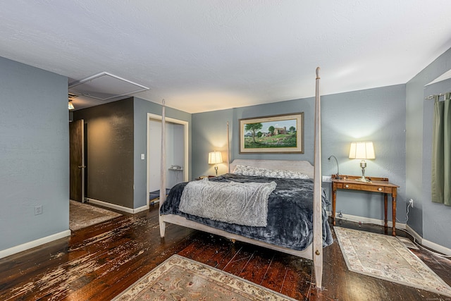 bedroom with dark wood-type flooring