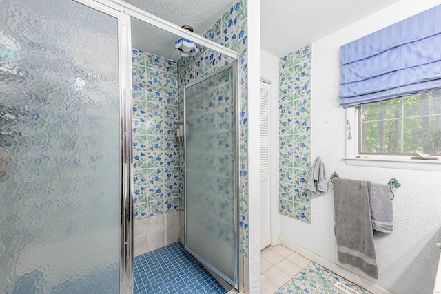 bathroom featuring tile patterned flooring and an enclosed shower