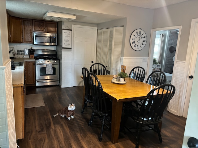 dining space with dark hardwood / wood-style floors and sink