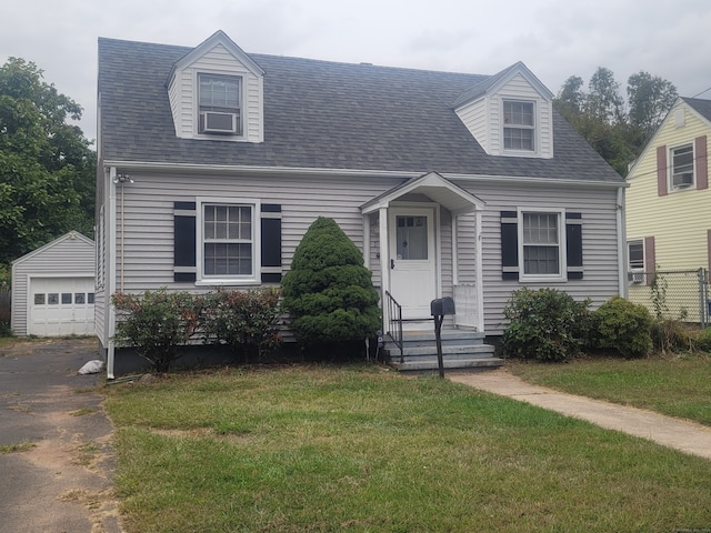 cape cod home with cooling unit, a front lawn, an outbuilding, and a garage