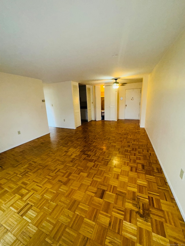 spare room featuring parquet flooring and ceiling fan