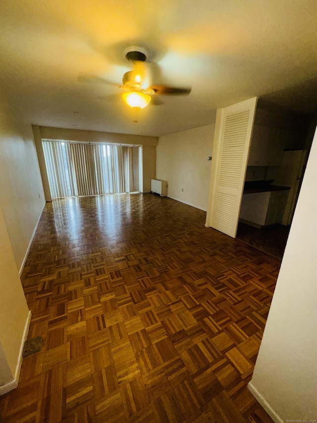 unfurnished room featuring baseboards and ceiling fan