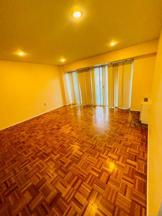 unfurnished room featuring parquet flooring