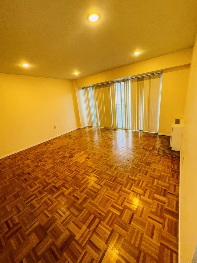 unfurnished room featuring baseboards and recessed lighting