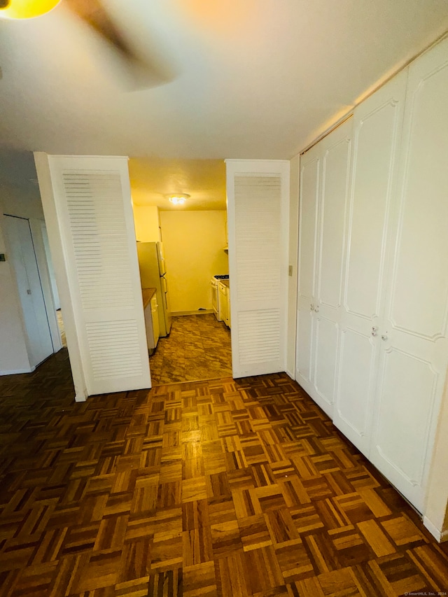 corridor featuring dark parquet floors