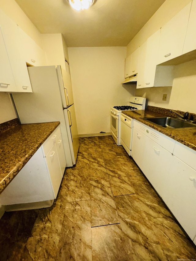 kitchen with white cabinets, under cabinet range hood, a sink, and white appliances