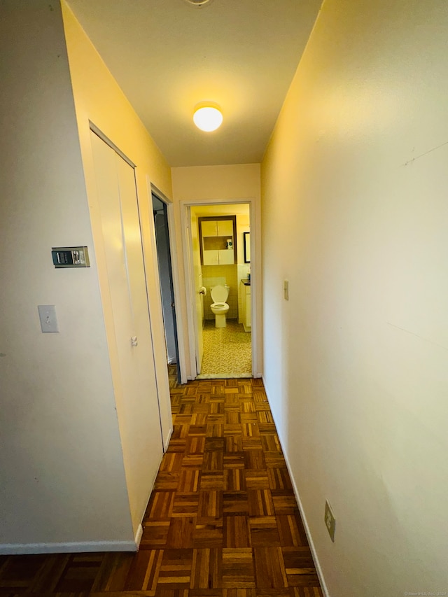 hall with dark parquet flooring