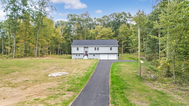 split foyer home with a garage and a front lawn