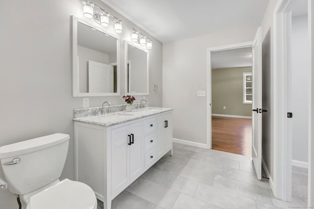 bathroom featuring vanity, toilet, and tile patterned floors