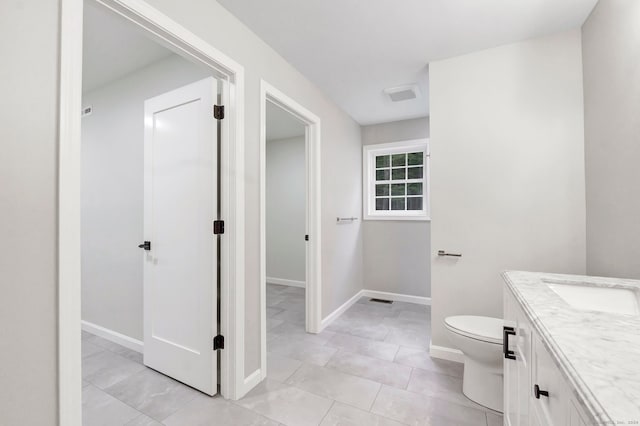 bathroom with vanity, toilet, and tile patterned flooring