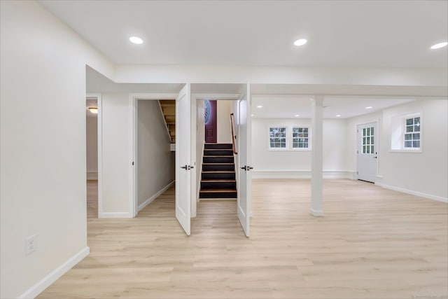 basement with light hardwood / wood-style flooring