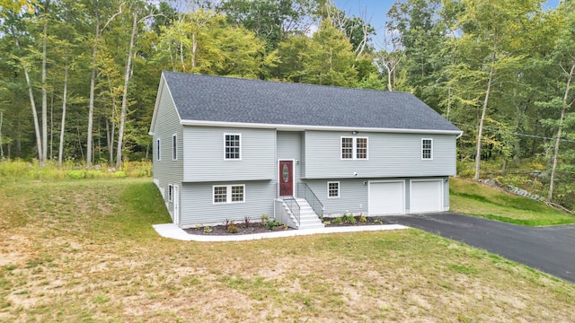 bi-level home featuring a front yard and a garage