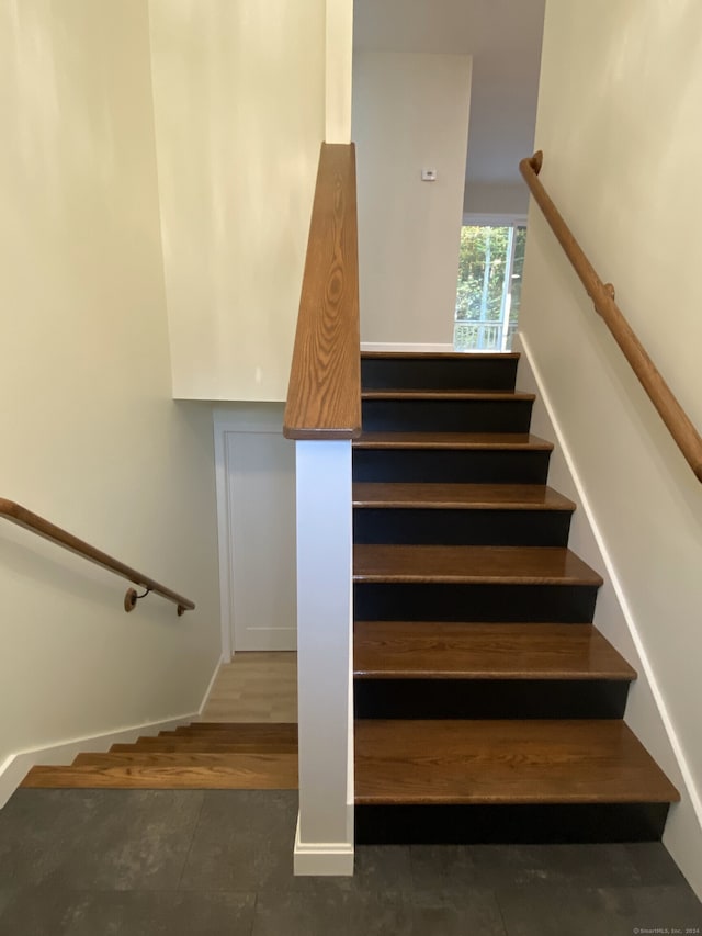 stairs with hardwood / wood-style floors