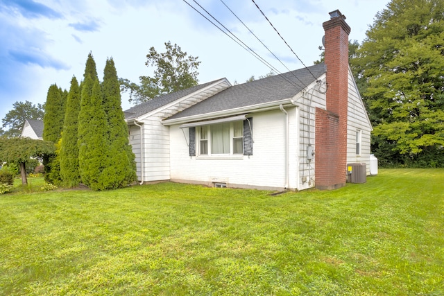 view of home's exterior with central AC unit and a lawn