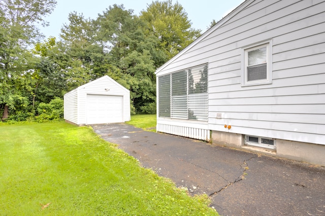 view of home's exterior with a garage, a yard, and an outdoor structure