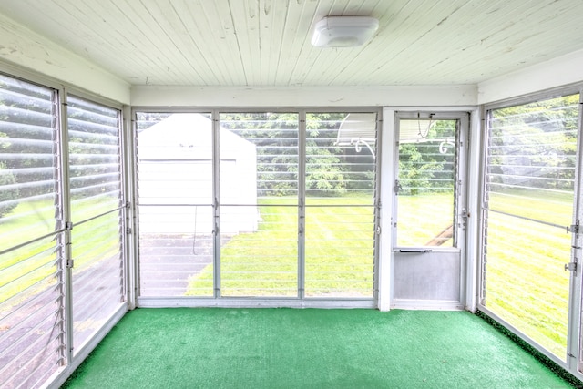 unfurnished sunroom featuring plenty of natural light and wooden ceiling