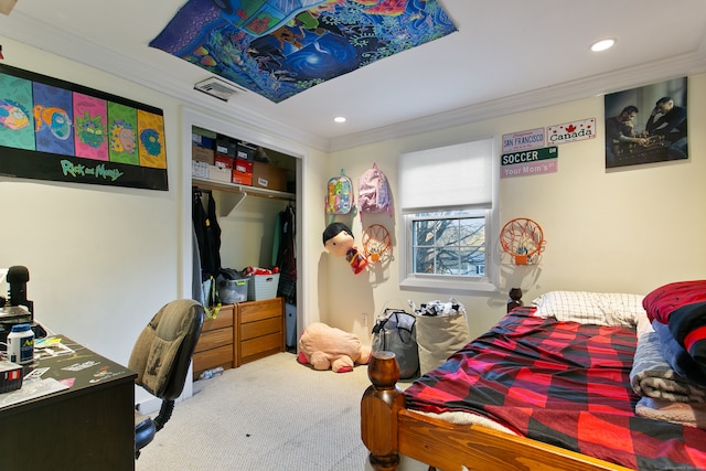 bedroom featuring ornamental molding, a closet, and carpet floors