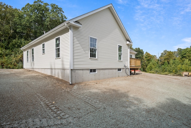 view of home's exterior featuring a wooden deck