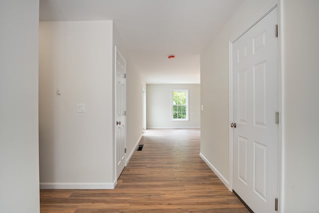 hallway featuring dark hardwood / wood-style flooring