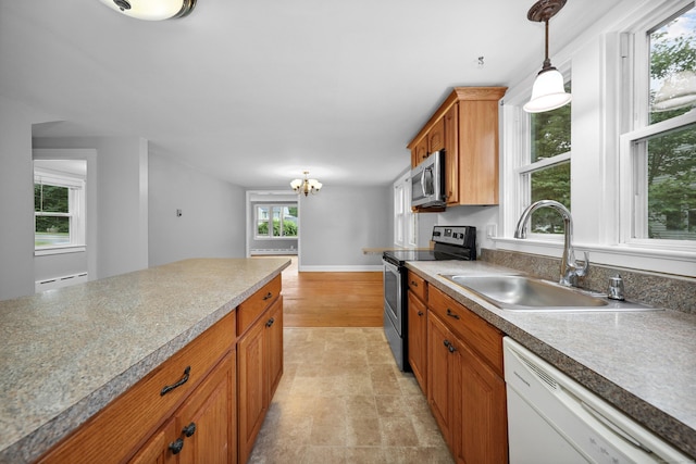 251 Stevens St, Bristol, CT 06010 - kitchen with appliances with stainless steel finishes, brown cabinets, decorative light fixtures, a chandelier, and light countertops