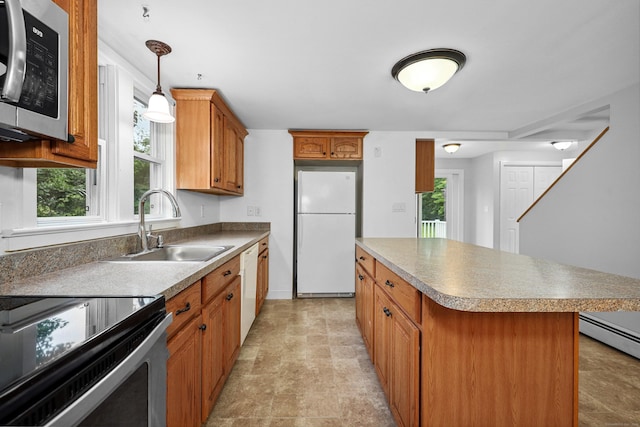 251 Stevens St, Bristol, CT 06010 - kitchen featuring appliances with stainless steel finishes, a kitchen island, brown cabinets, hanging light fixtures, and a baseboard radiator