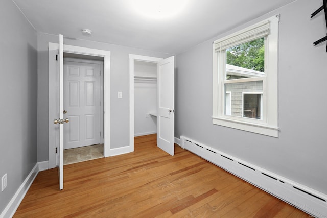 251 Stevens St, Bristol, CT 06010 - unfurnished bedroom with a baseboard radiator, light wood-type flooring, and a closet