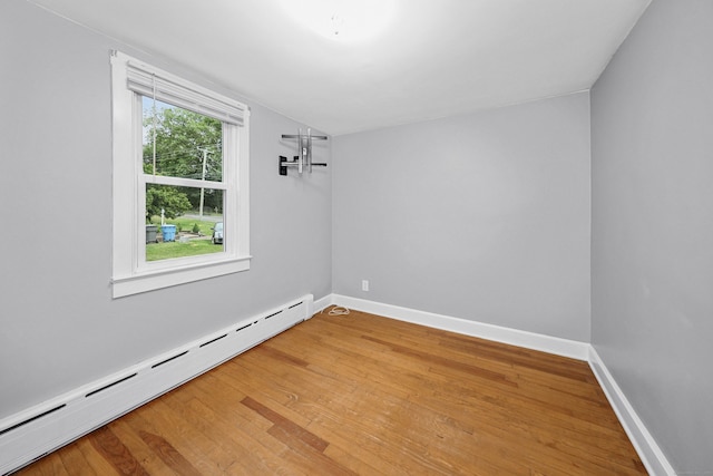 251 Stevens St, Bristol, CT 06010 - spare room featuring baseboard heating, light wood-style flooring, and vaulted ceiling