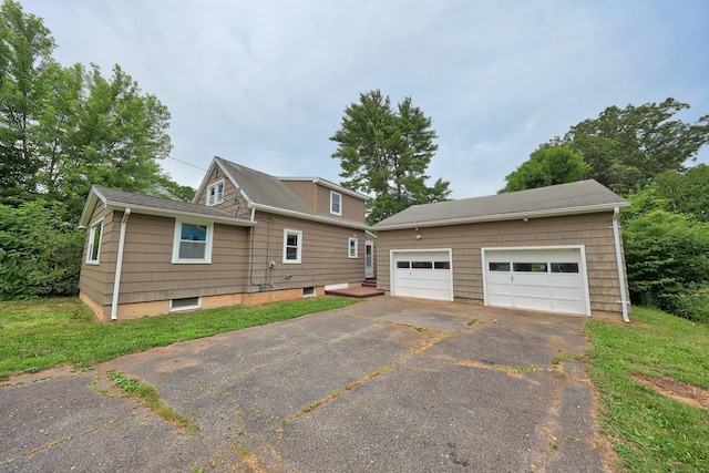 251 Stevens St, Bristol, CT 06010 - view of side of property with an outdoor structure and a detached garage