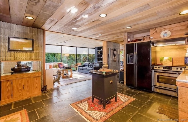 kitchen with wood ceiling, electric stove, wood walls, and black refrigerator with ice dispenser