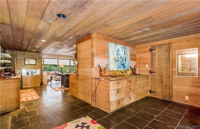 hallway with wooden walls and wood ceiling