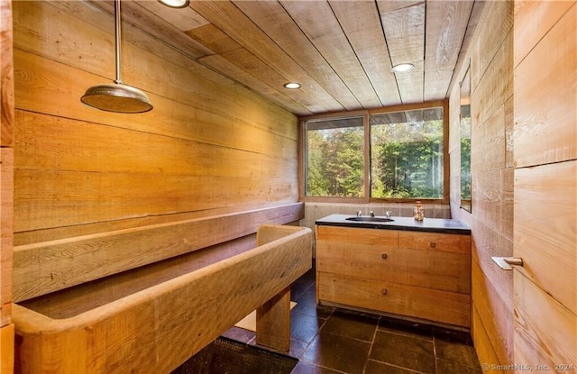 view of sauna with wood ceiling, wood walls, and tile patterned floors